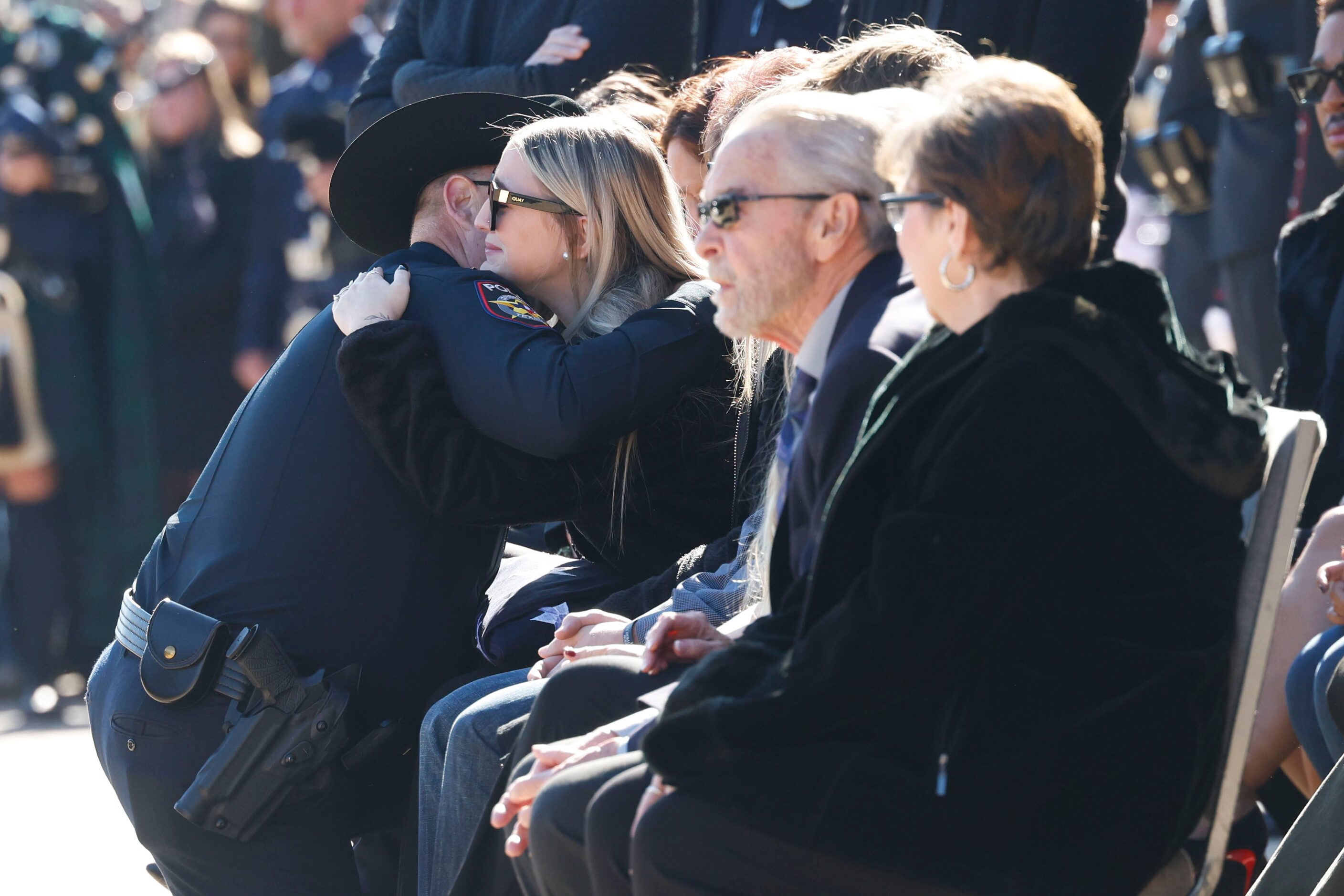 Greenville Police Chief Christopher Smith (left) shares a hug with Greenville police officer...