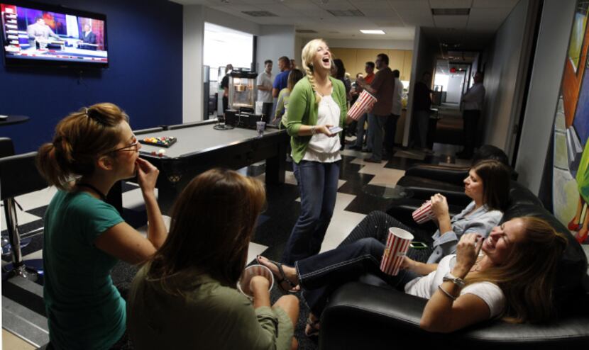 lsey Vross, center, jokes with her co-workers at The Marketing Arm in their weekly "3...