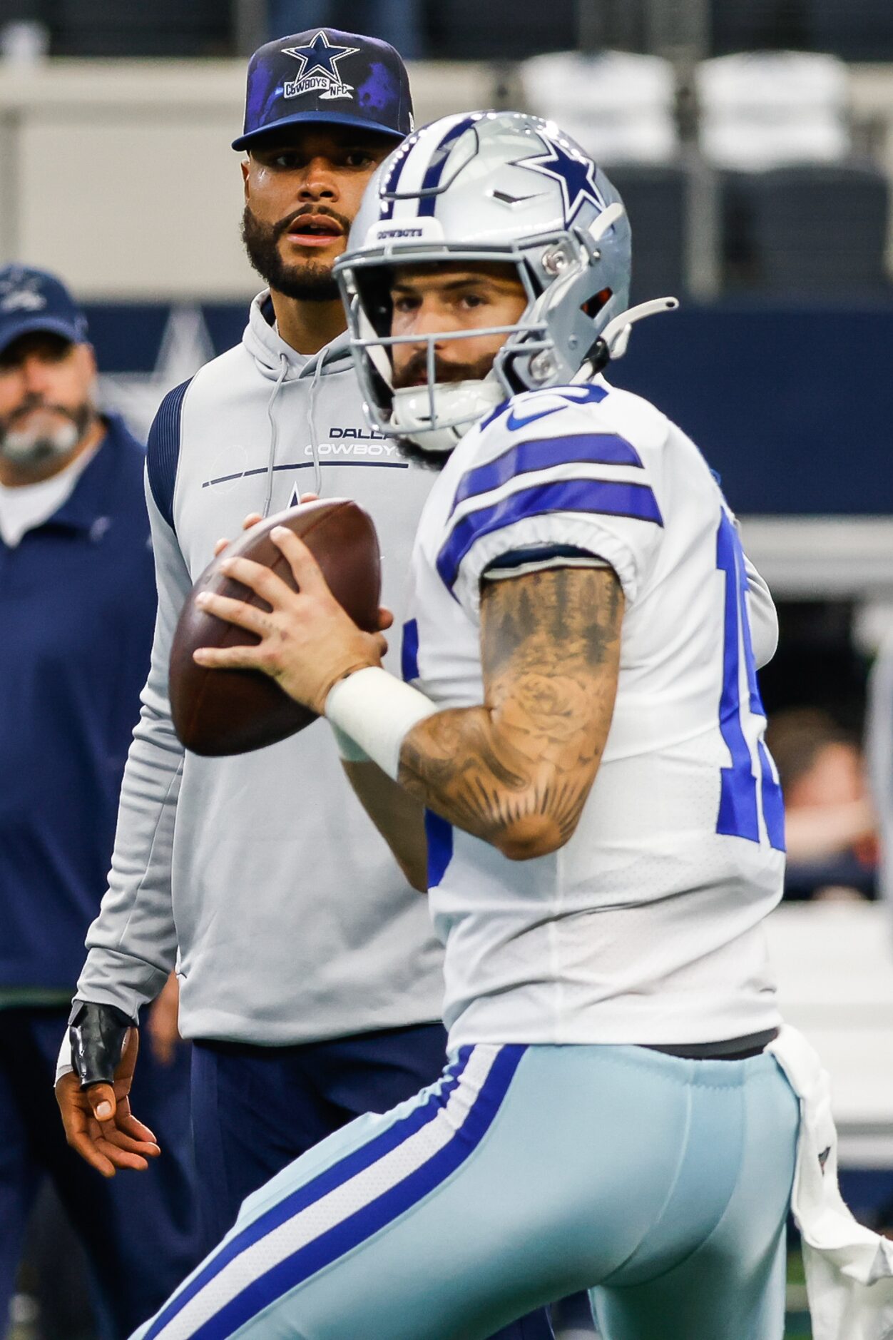 Dallas Cowboys quarterback Dak Prescott (4) watches quarterback Will Grier (15) during...