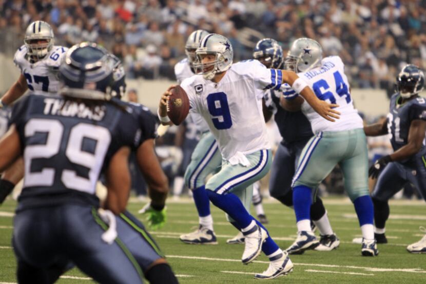 Dallas Cowboys quarterback Tony Romo (9) scrambles for yardage against Seattle in the first...