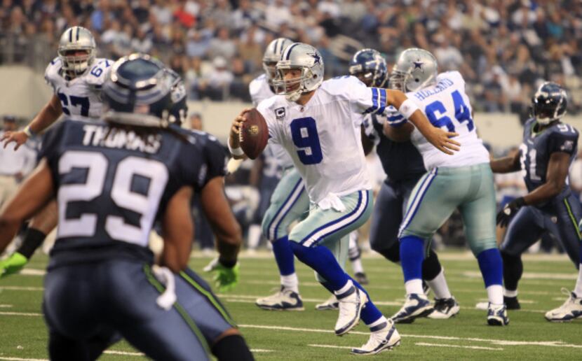 Dallas Cowboys quarterback Tony Romo (9) scrambles for yardage against Seattle in the first...