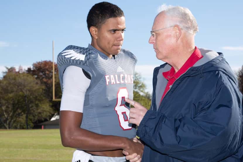 
Bishop Dunne quarterback Caleb Evans gets advice from Jeff Williamson of the Bishop Dunne...