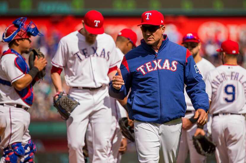 Texas Rangers manager Jeff Banister heads to the dugout after replacing relief pitcher Matt...