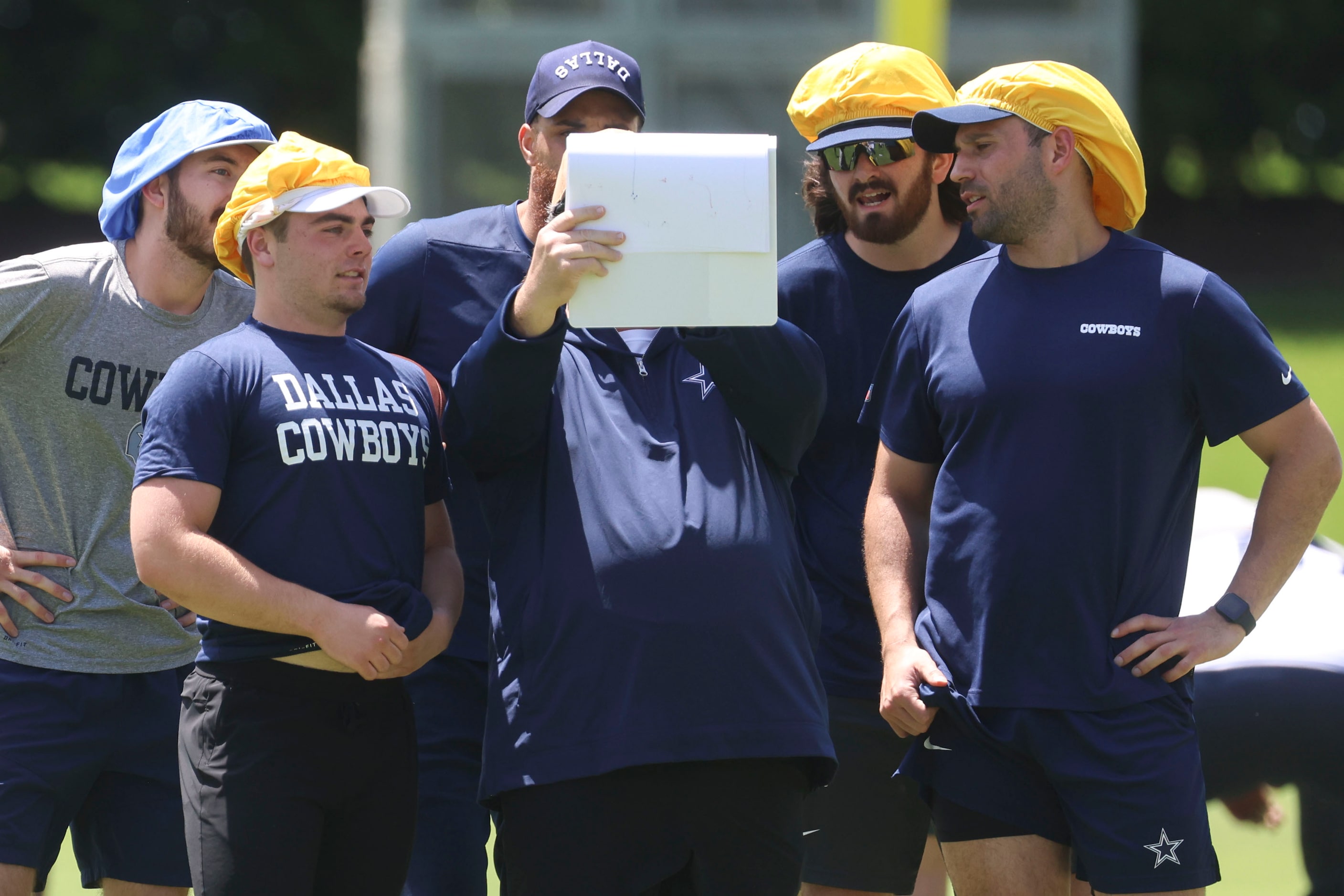 Dallas Cowboys defensive run game coordinator Paul Guenther (center) instructs his team...