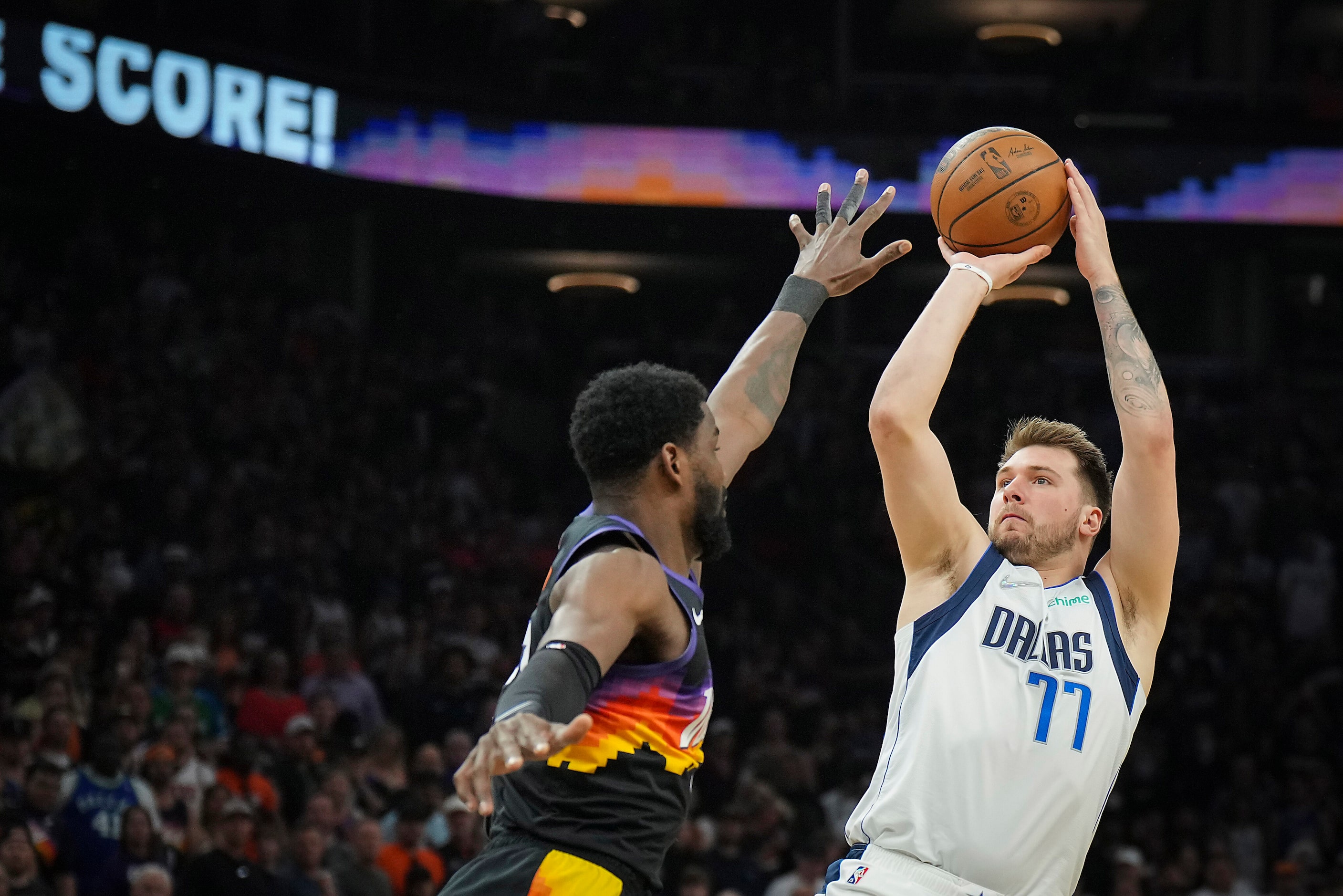 Dallas Mavericks guard Luka Doncic (77) shoots a 3-pointer over Phoenix Suns center Deandre...