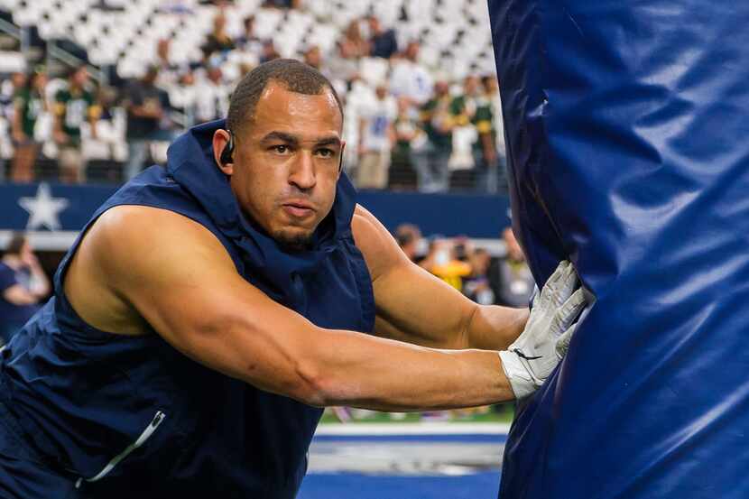 Dallas Cowboys defensive tackle Tyrone Crawford warms up before an NFL football game against...