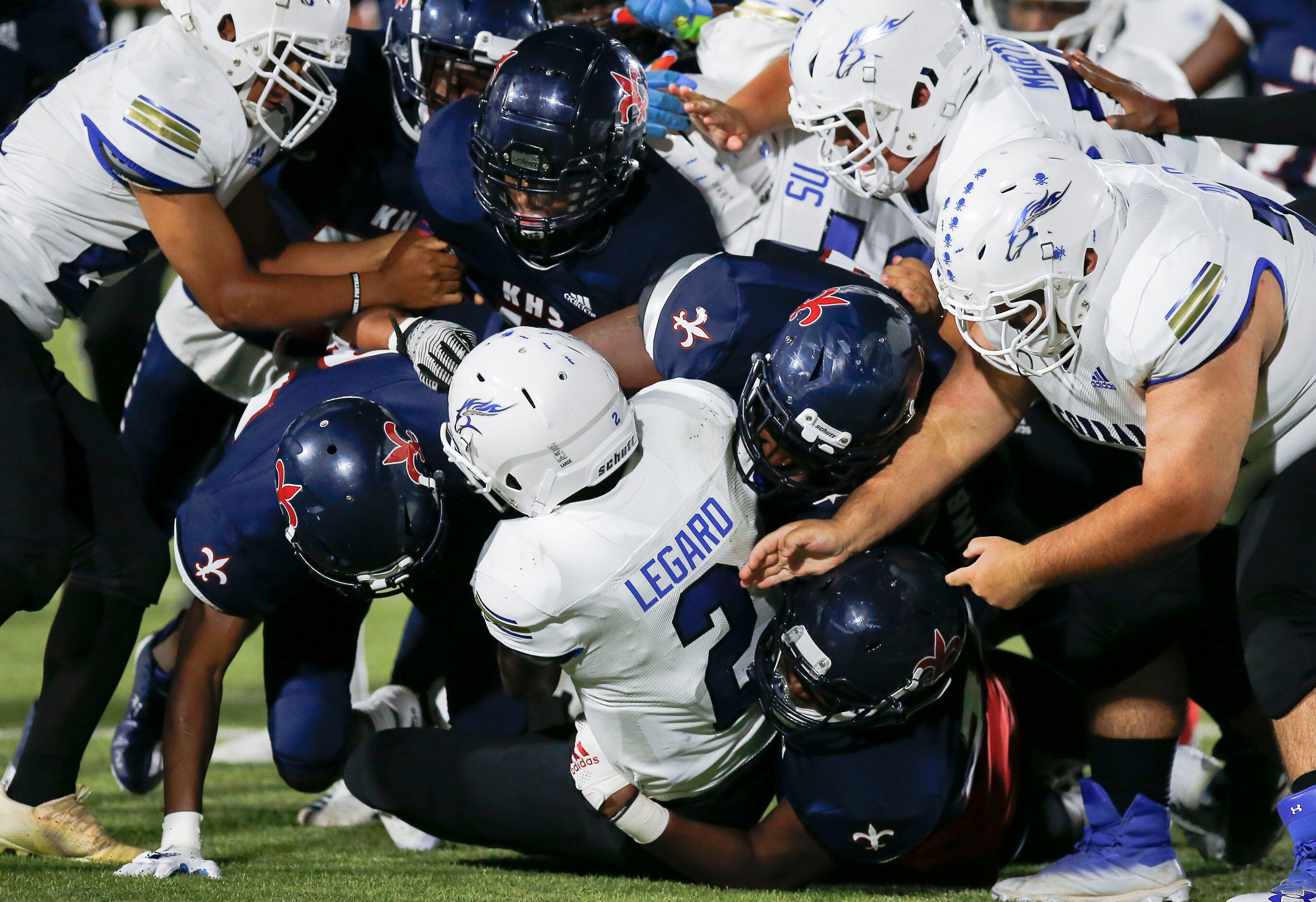 Conrad junior quarterback Chris Legard (2) is tackled by the Kimball defense during the...