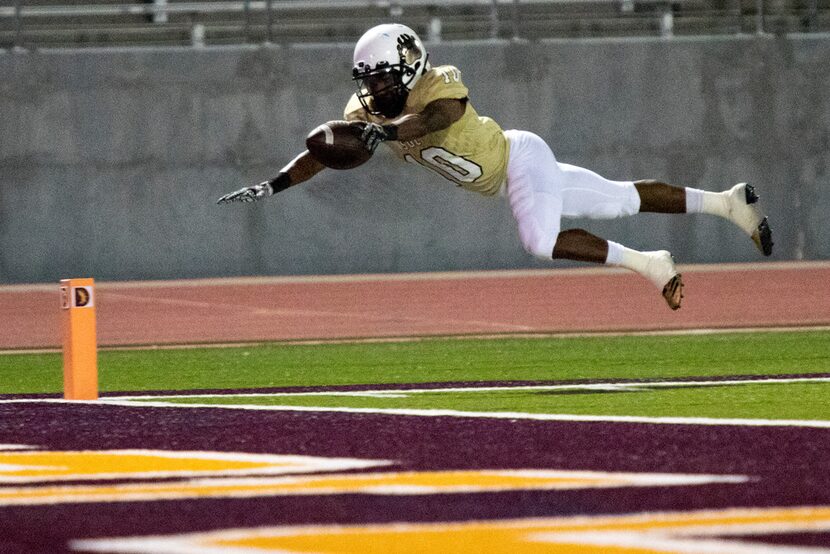 South Oak Cliff running back Rickey Wren (10) dives towards the endzone in an attempt to...