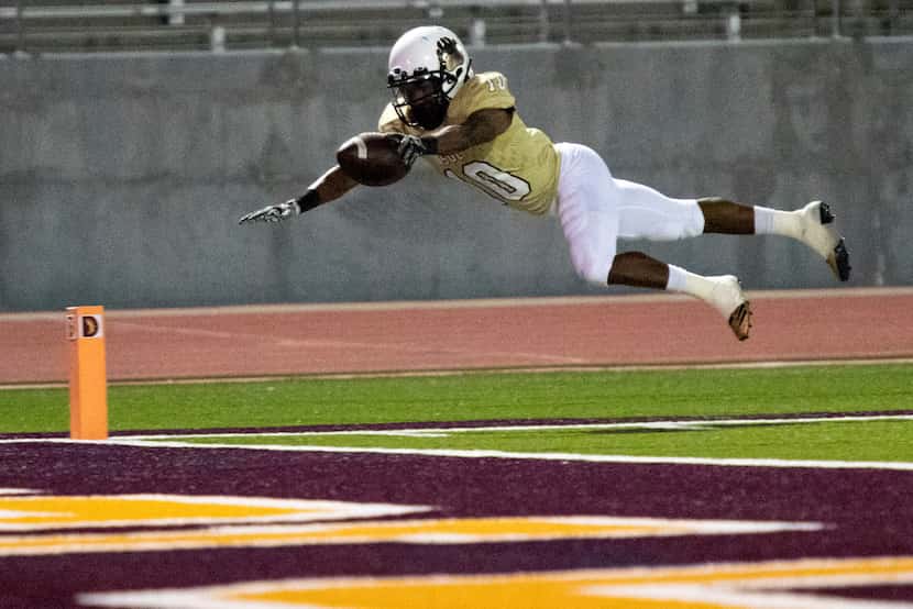 South Oak Cliff running back Rickey Wren (10) dives towards the endzone in an attempt to...