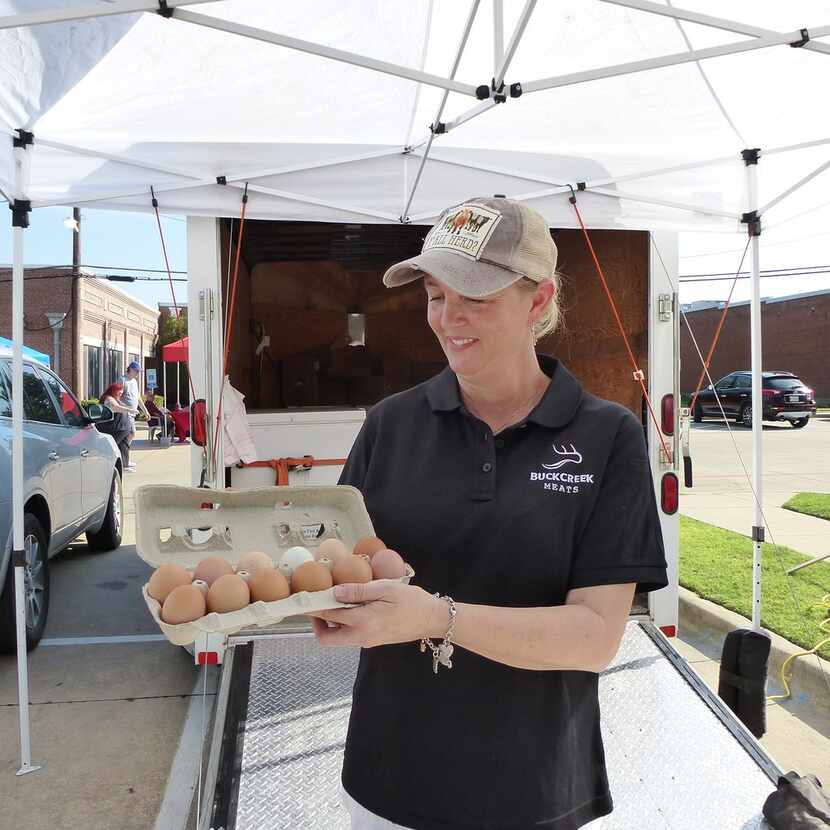 Mona Gregory holds up her Buck Creek Land and Cattle free-range eggs at Frisco Rotary...