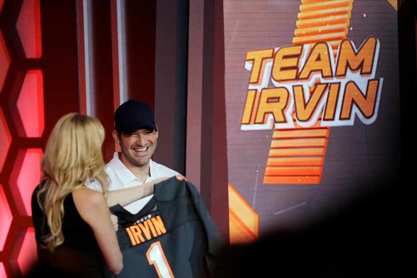 Dallas Cowboys' Tony Romo is presented a jersey after being picked to play on Team Irvin,...
