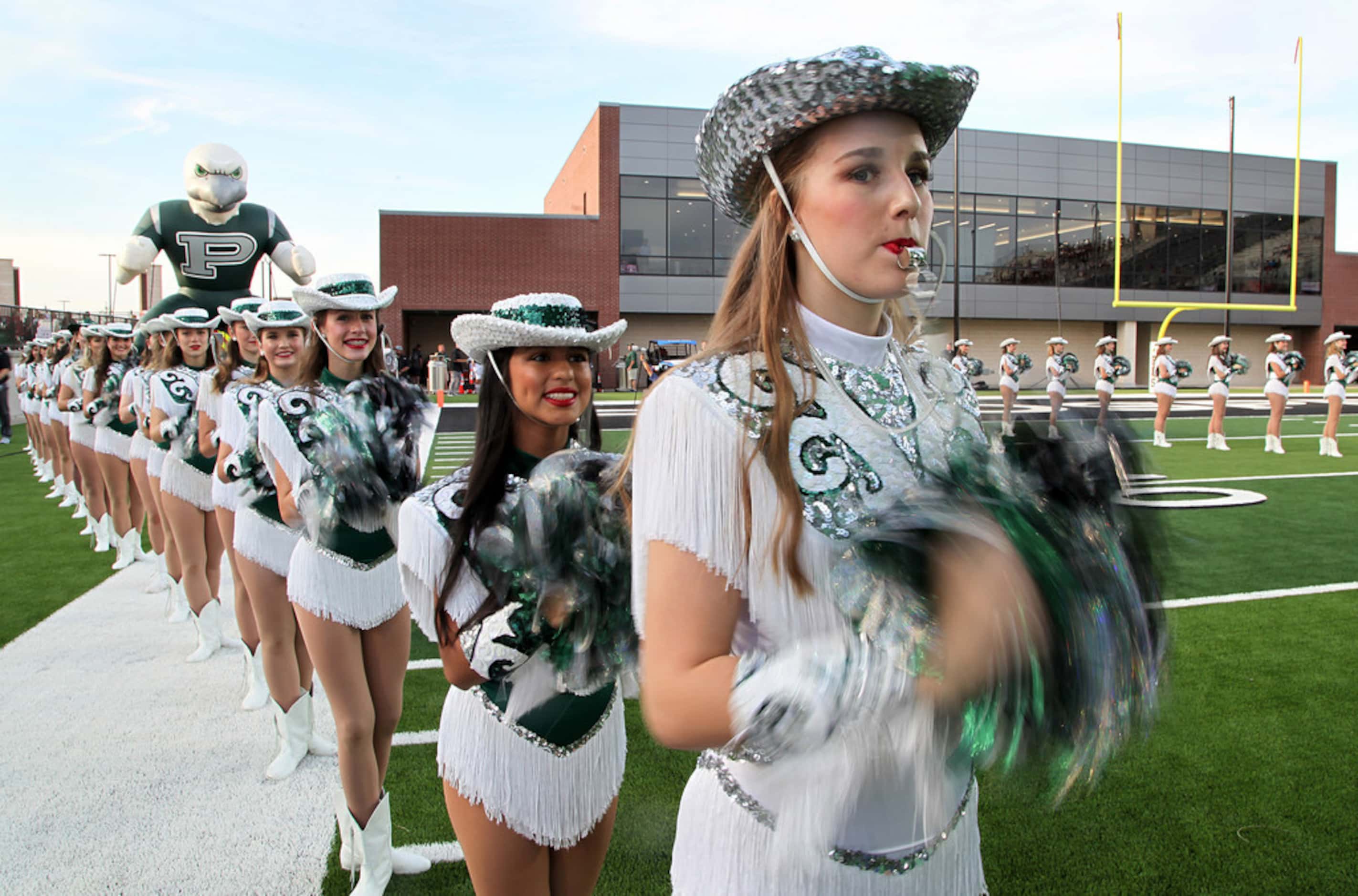 Alexa Wheeler, a captain with the Prosper High School Talonettes, stands at attention before...
