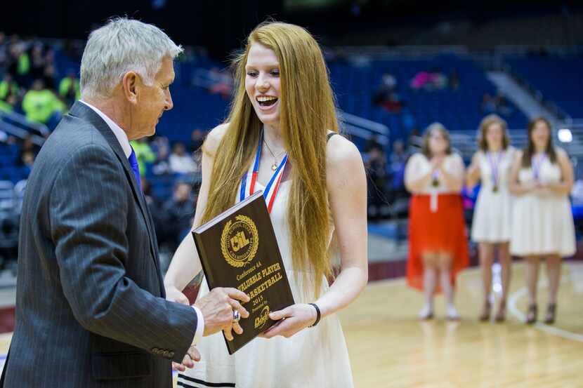 UIL Executive Director Dr. Charles Breithaupt presents Argyle forward Vivian Gray (12) with...