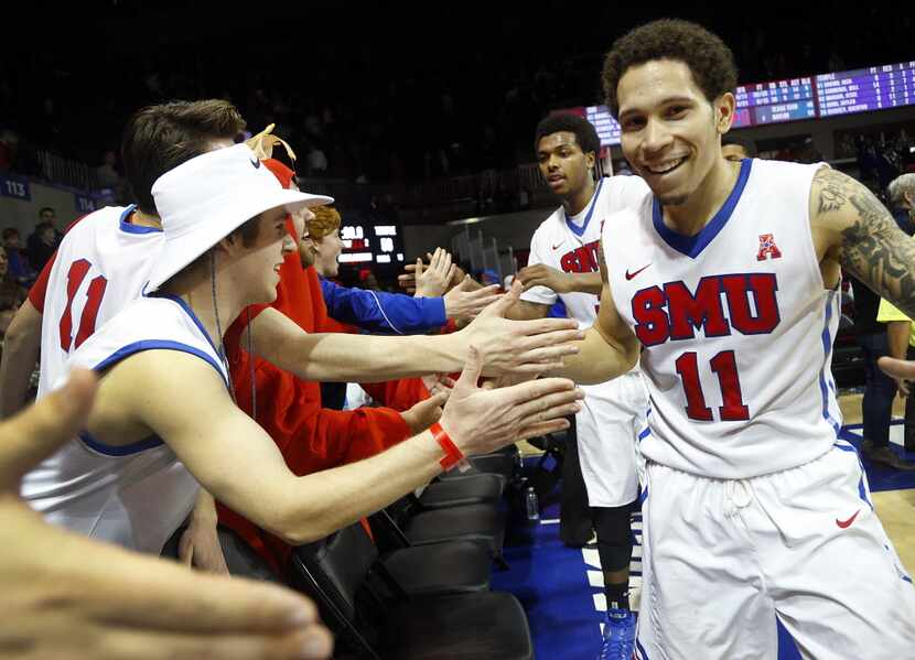Southern Methodist Mustangs guard Nic Moore (11) slaps hands with fans following their 67-58...