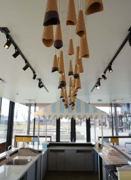 Margaret’s Cones & Cups is an ice cream shop at Omni PGA Frisco that has light fixtures that...