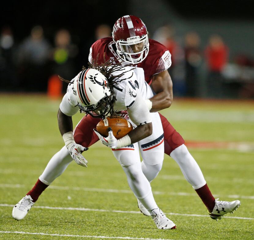 FILE - In this Sept. 12, 2015, file photo, Cincinnati running back Tion Green (7) is tackled...