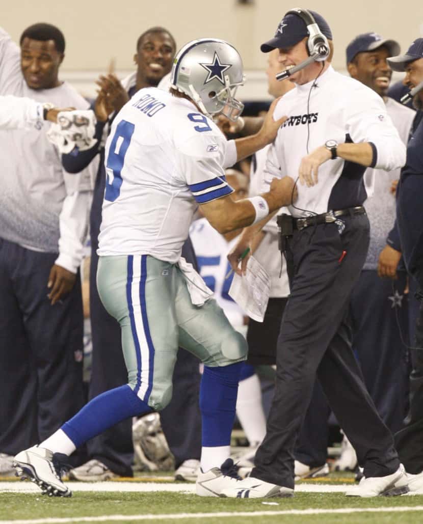 Cowboys quarterback Tony Romo and offensive coordinator Jason Garrett celebrate a touchdown...