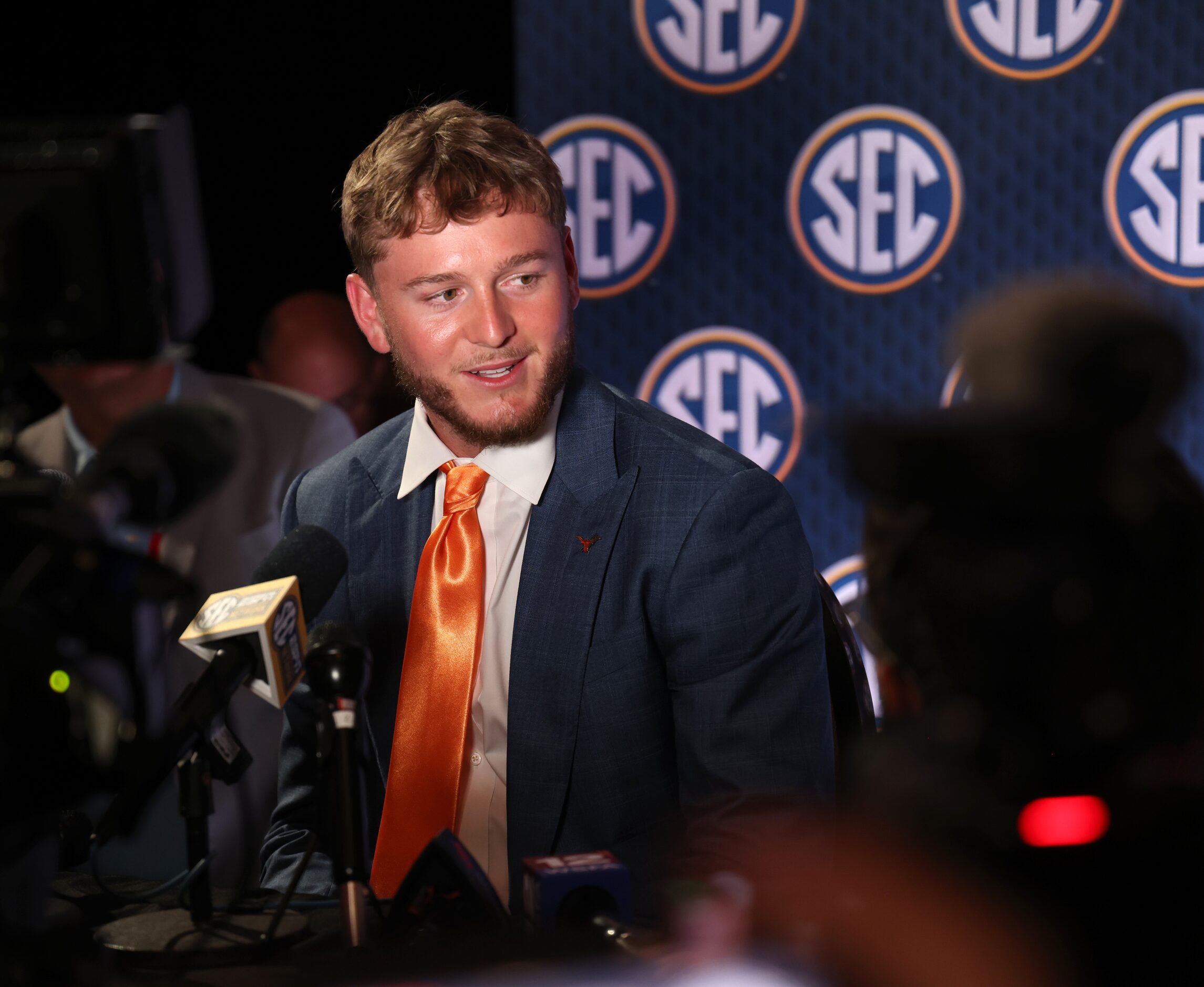 Texas Longhorns starting quarterback Quinn Ewers listens to a question from a media member...