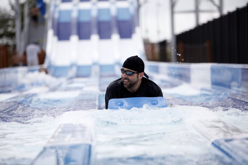 Jim White is among the first to ride the new 45-foot tall, four-lane mat racer at the Frisco...