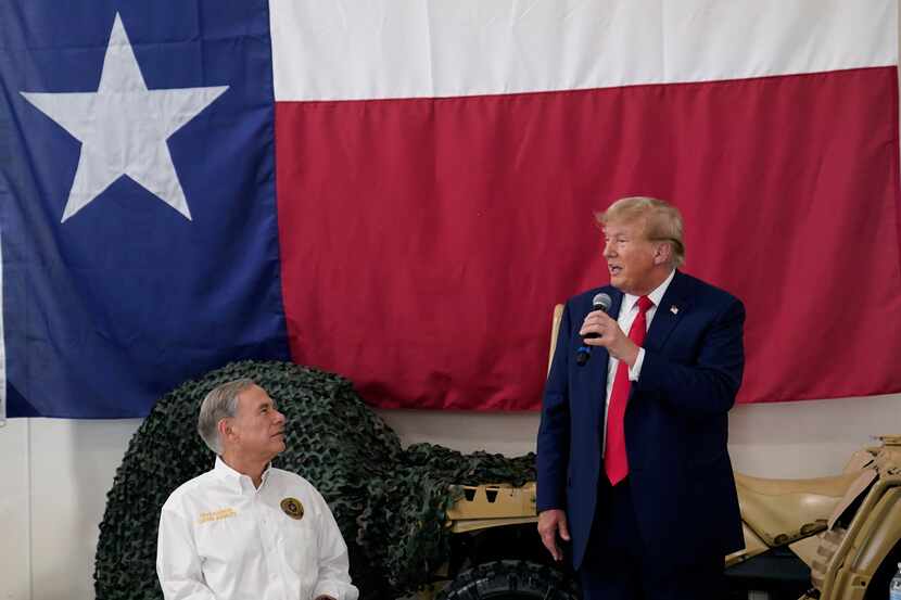 Texas Gov. Greg Abbott listens as former President Donald Trump speaks to Texas state...