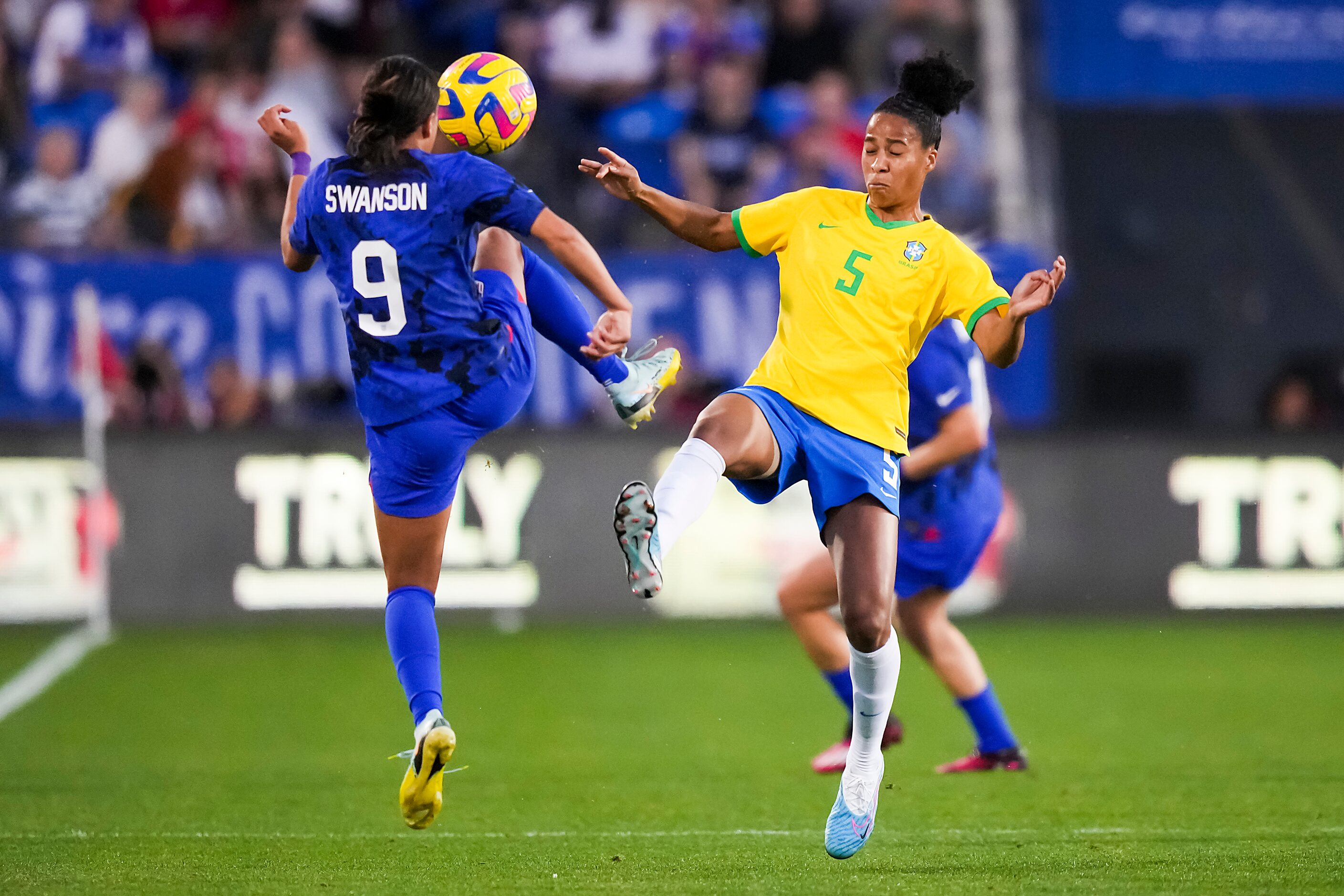 United States forward Mallory Swanson (9) challenges Brazil defender Tainara (5) for the...