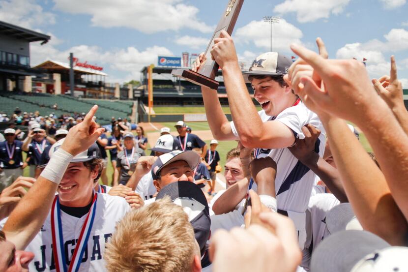 Lewisville Flower Mound players cheer with the trophy after their win against San Antonio...