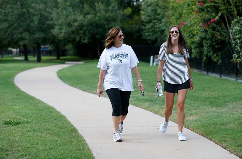 Amy Hardesty walks with Annika Rains near Fisher Elementary School in Frisco on Aug. 29....