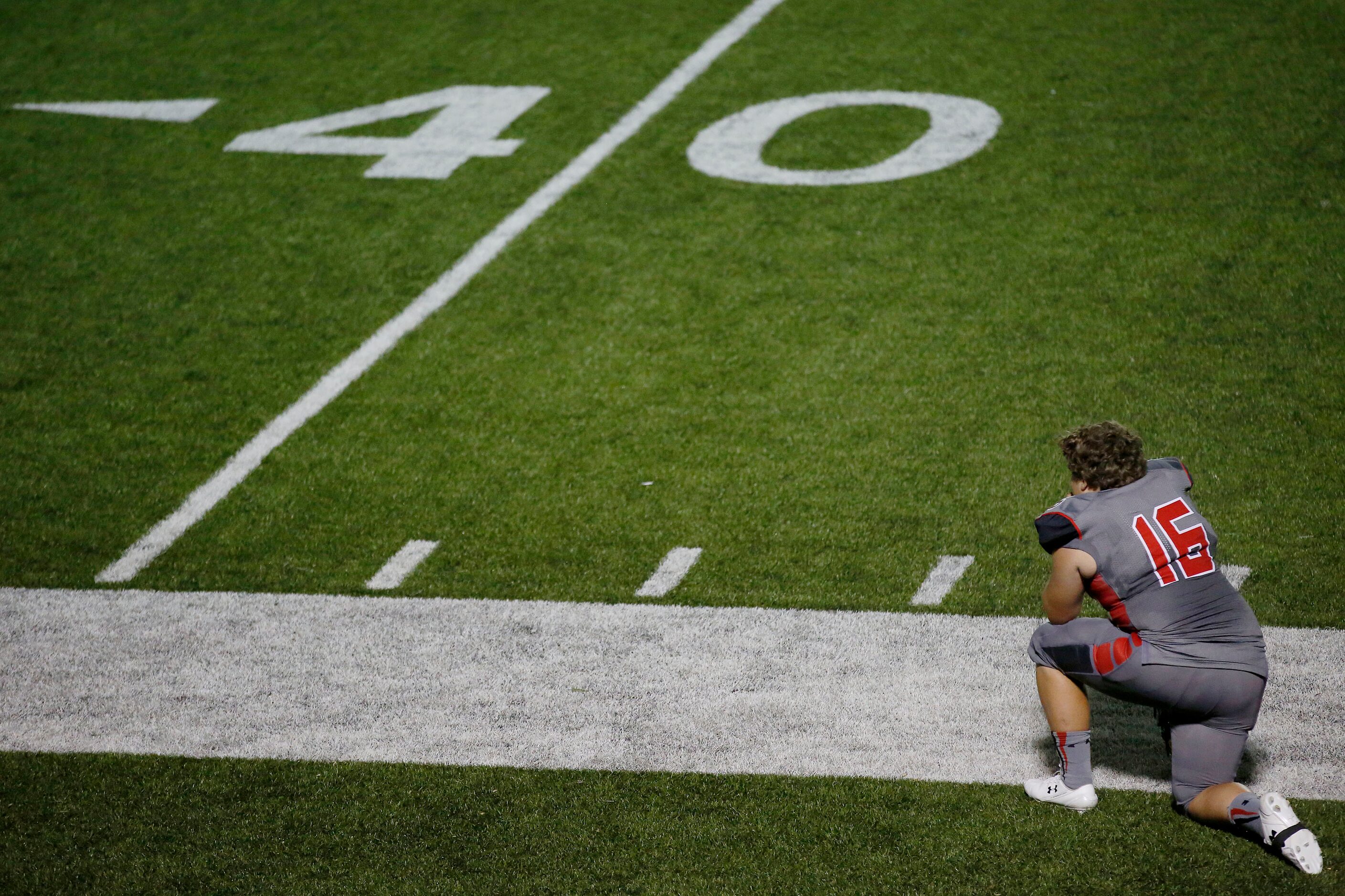 AAA Prime U kicker Brody Carrasco kneels on the sideline in the second half during a high...