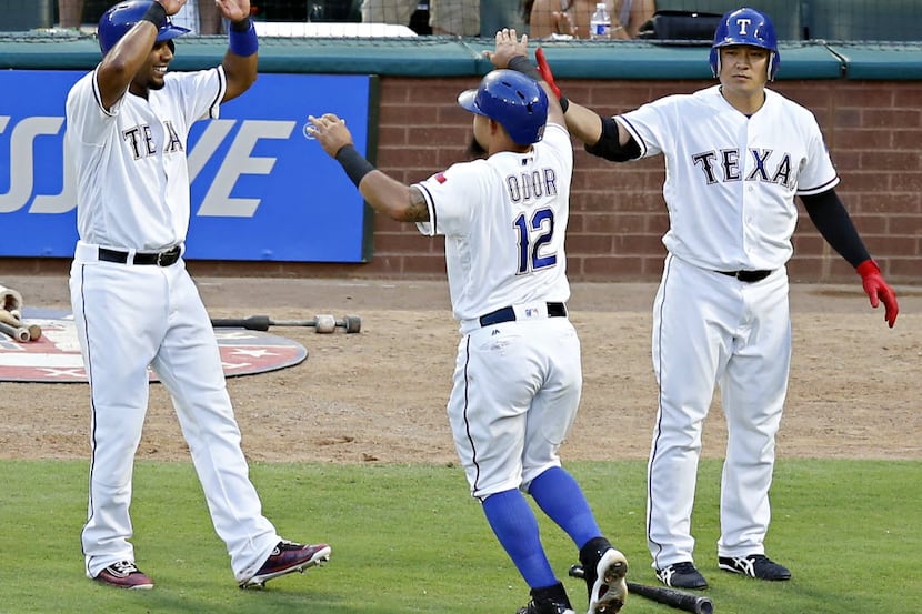 Texas Rangers shortstop Elvis Andrus (1) and second baseman Rougned Odor (12) celebrate...