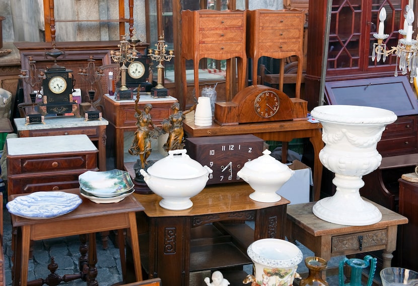 Antique furniture and housewares on display at a thrift store.