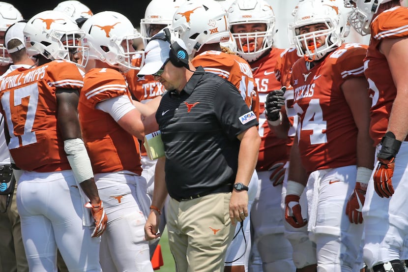 Texas head coach Tom Herman is pictured with his team during a time out in the third quarter...