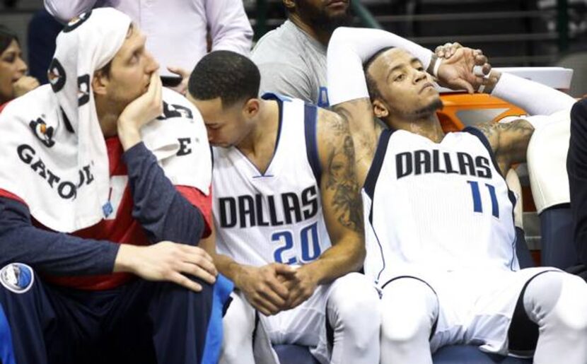 Dallas Mavericks guard Monta Ellis (11), guard Devin Harris (20) and forward Dirk Nowitzki...