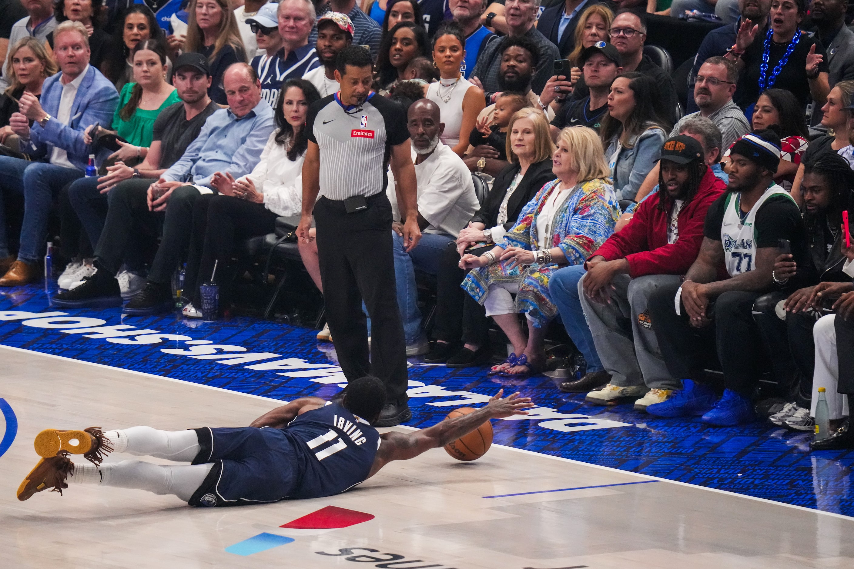 Dallas Mavericks guard Kyrie Irving (11) dives for a loose ball during the first half in...