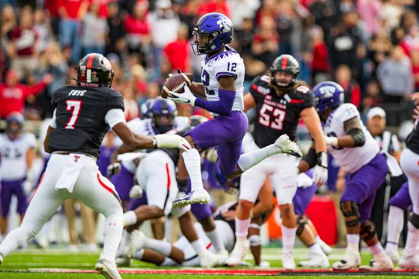 LUBBOCK, TEXAS - NOVEMBER 16: Wide receiver Derius Davis #12 of the TCU Horned Frogs leaps...