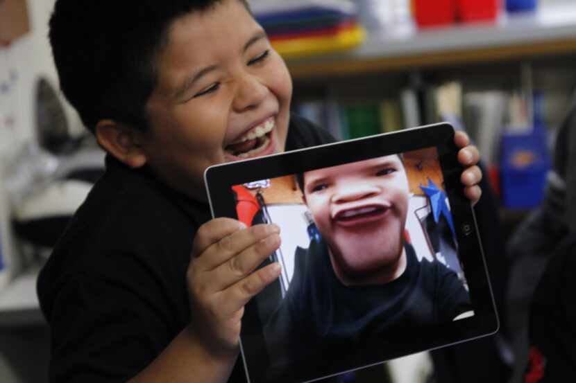 Isaac Sigala laughed at the distorted photo of himself that he took with one of the iPads...