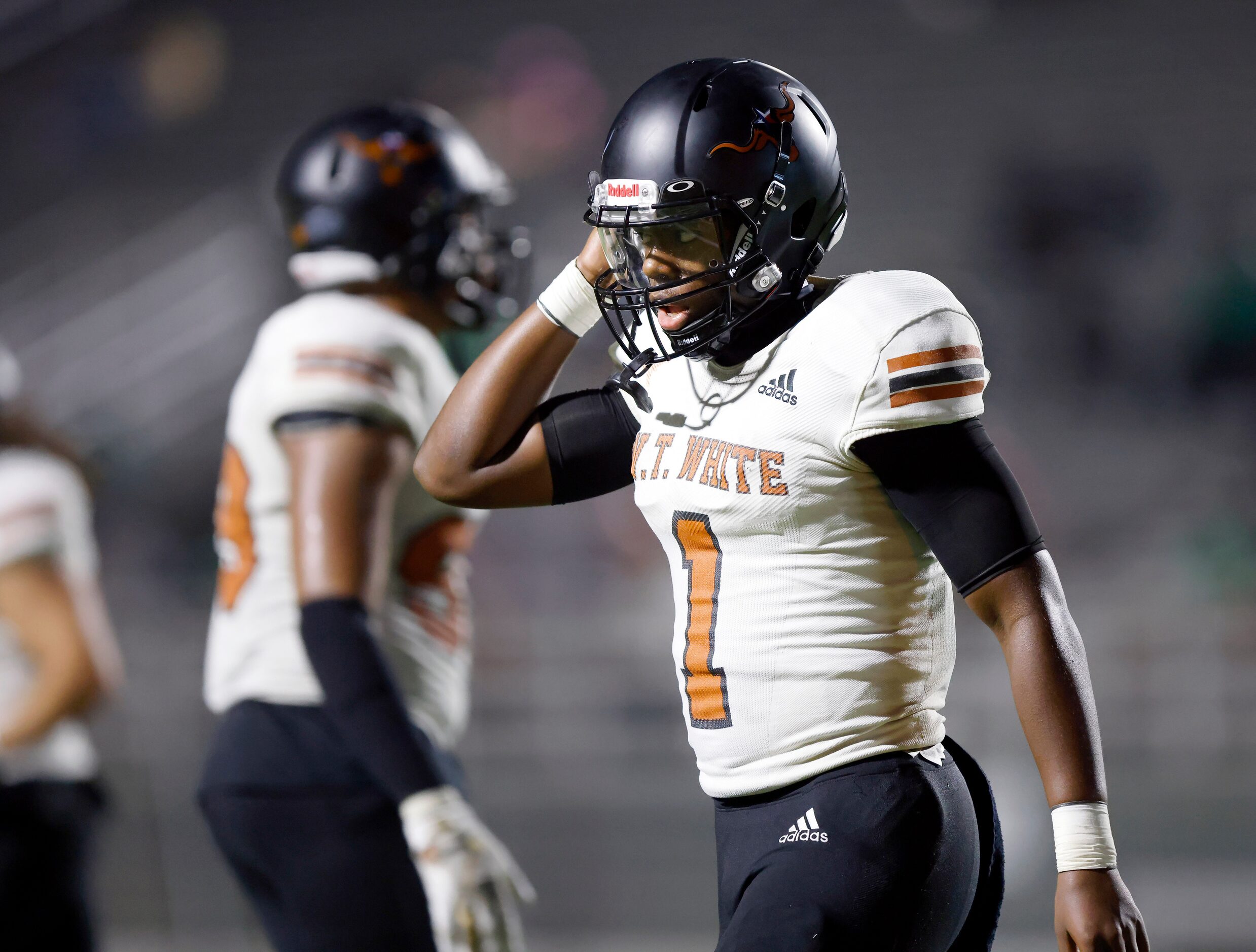 W.T. White quarterback Jaydyn Sisk (1) walks to the bench after throwing a second quarter...