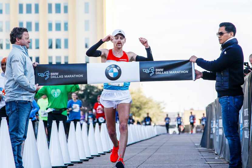 Colby-Wayne Mehmen, of Princeton, Texas runs past the finish line while  being the first...