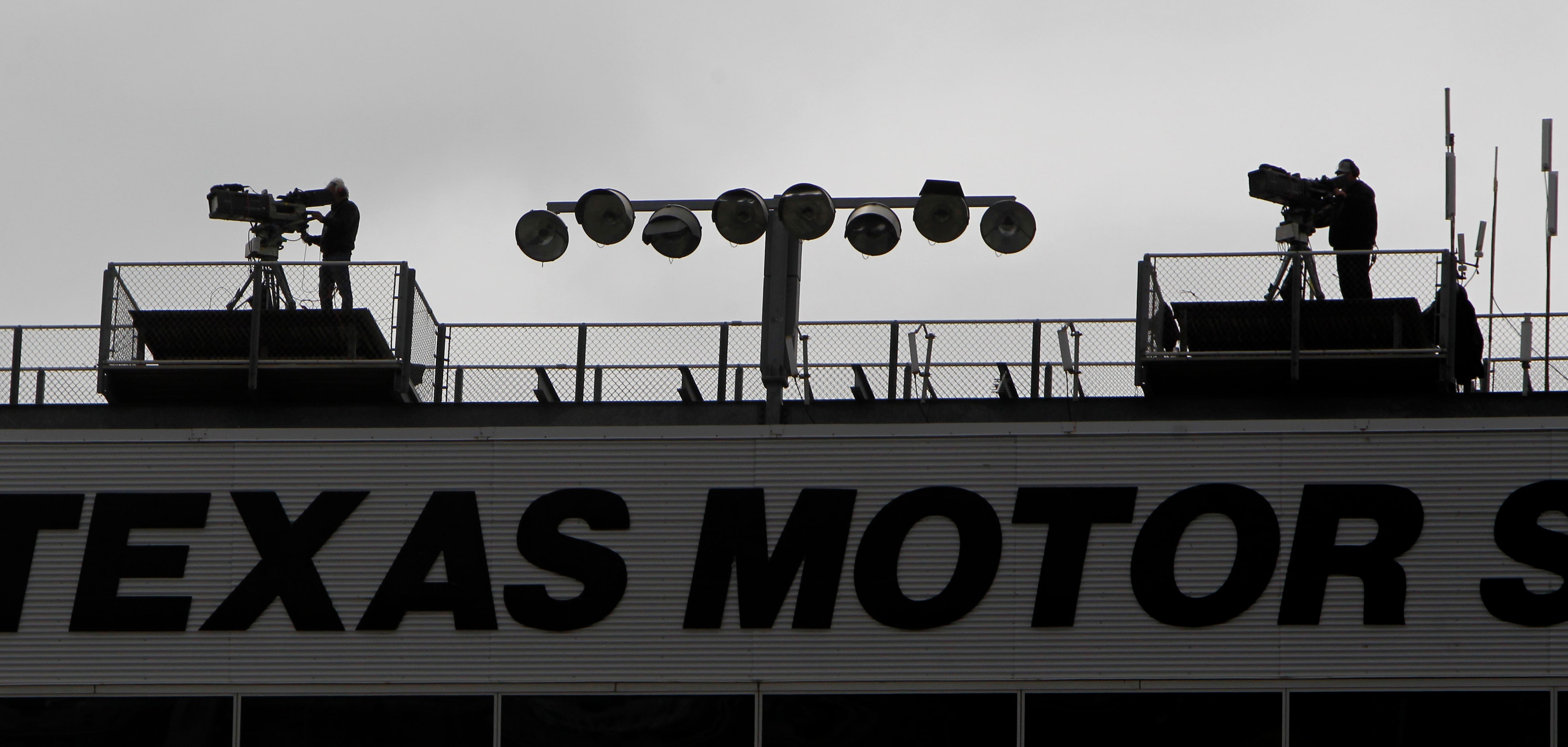 A pair of network camera operators record the race from a birds-eye-view from atop the...