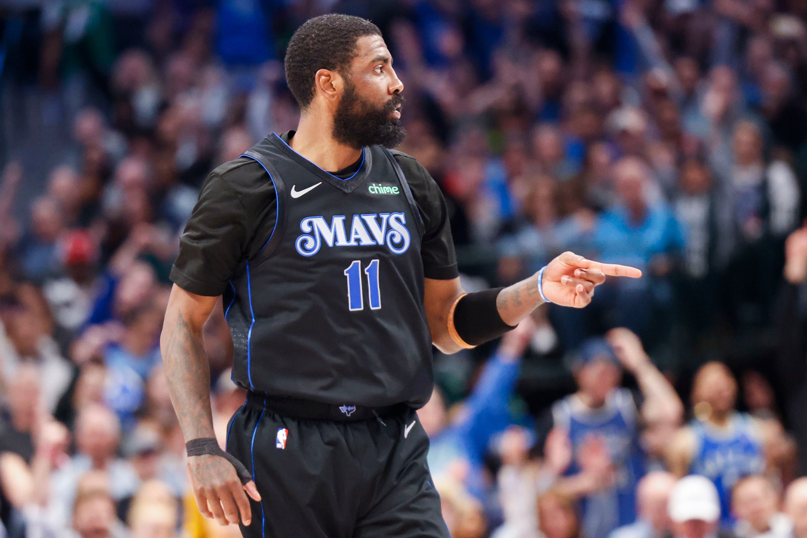 Dallas Mavericks guard Kyrie Irving reacts after scoring from a three-pointer during the...