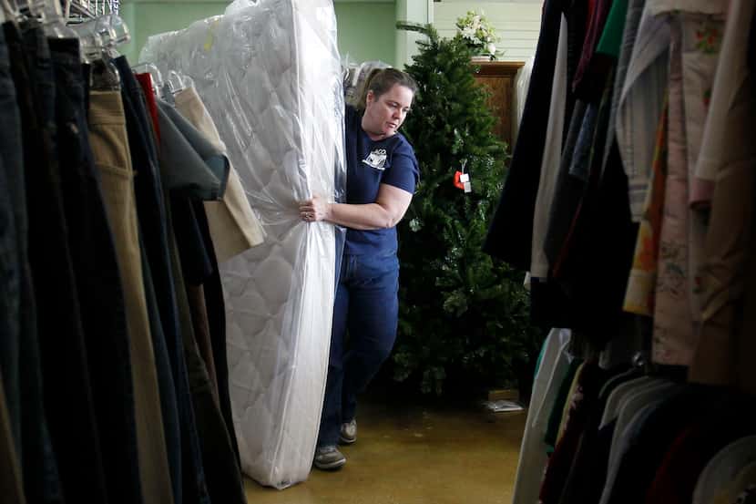 Kristina Marsey moves mattresses inside the Allen Community Outreach Resale Shop at Allen...