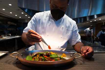 Chef Junior Borges puts the final touches on the grilled octopus at Meridian in Dallas in 2021.