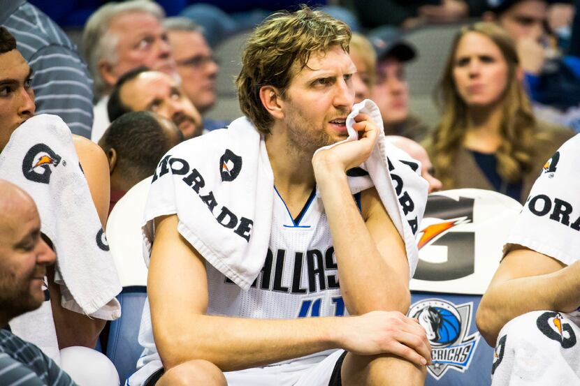 Dallas Mavericks forward Dirk Nowitzki watches from the bench during the final minutes of a...