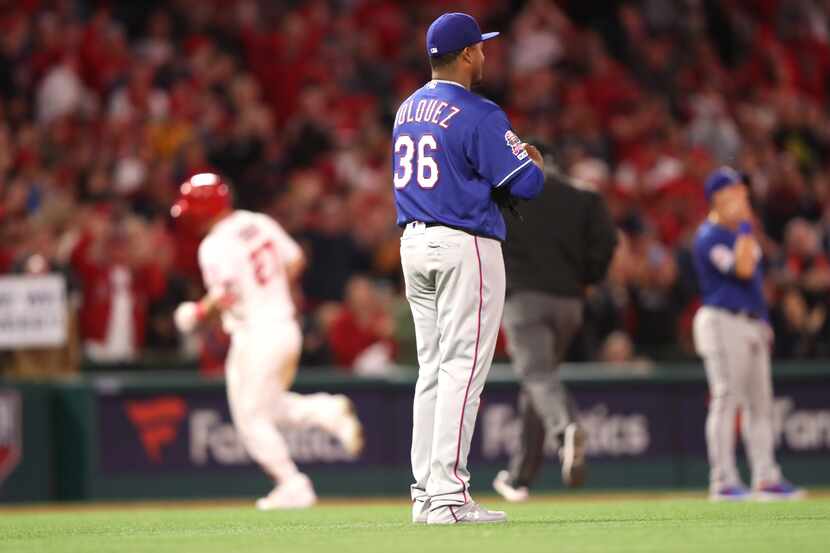 ANAHEIM, CALIFORNIA - APRIL 04:  Edinson Volquez #36 of the Texas Rangers looks on as Mike...