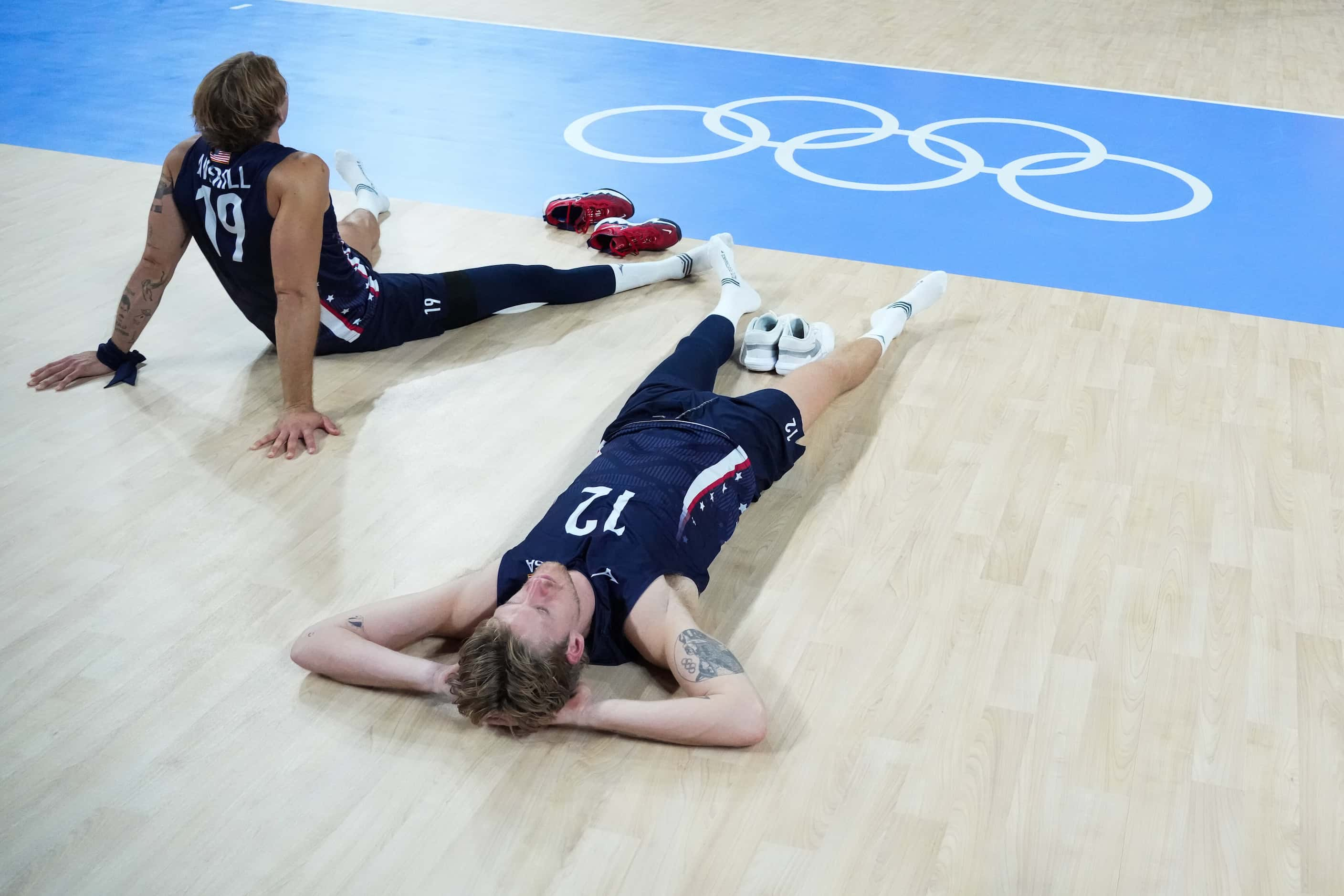 Taylor Averill (19) and Maxwell Holt (12) of the United States linger on the court after a...