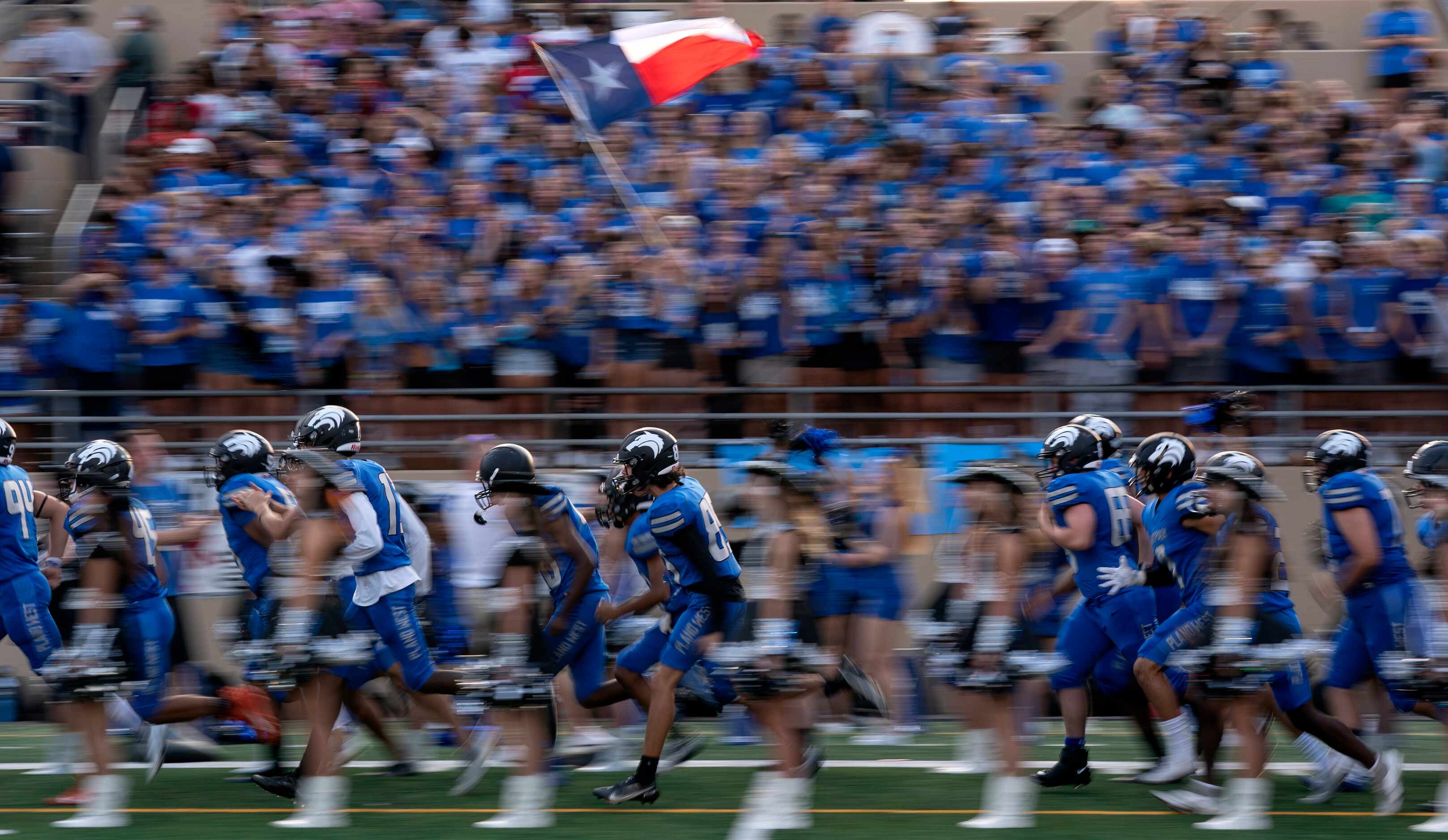 Plano West takes the field before a high school football game against Little Elm on Friday,...