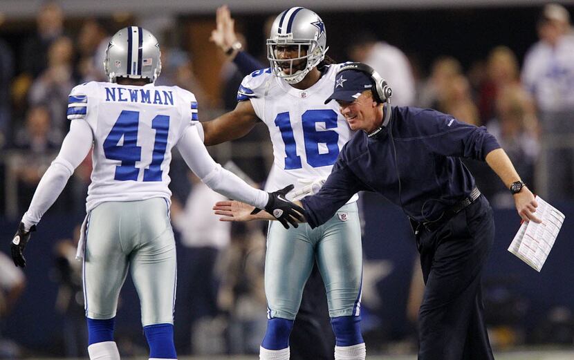 Dallas Cowboys head coach Jason Garrett congratulates  cornerback Terence Newman (41) on...