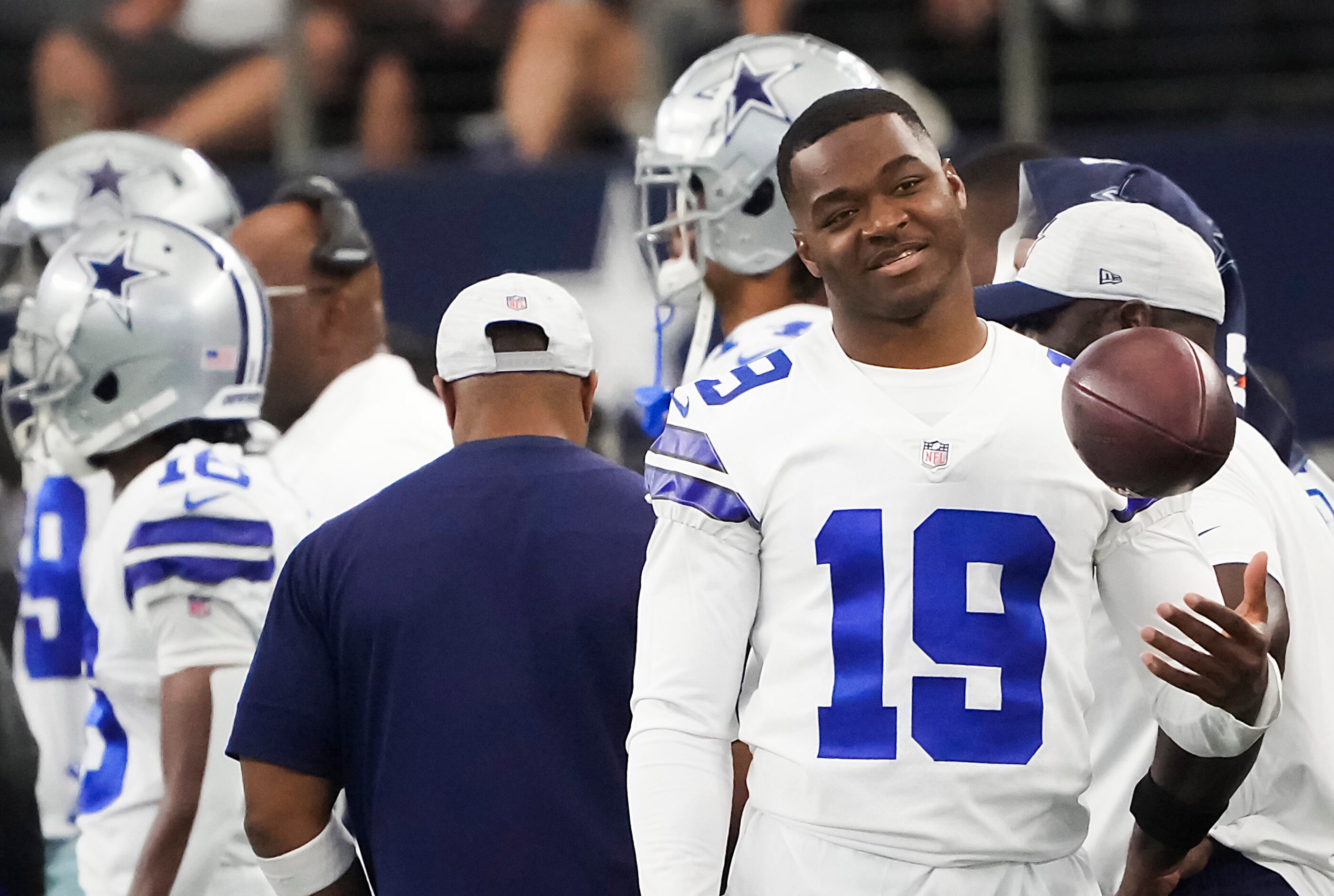 Dallas Cowboys wide receiver Amari Cooper tosses a ball on the sidelines during the first...