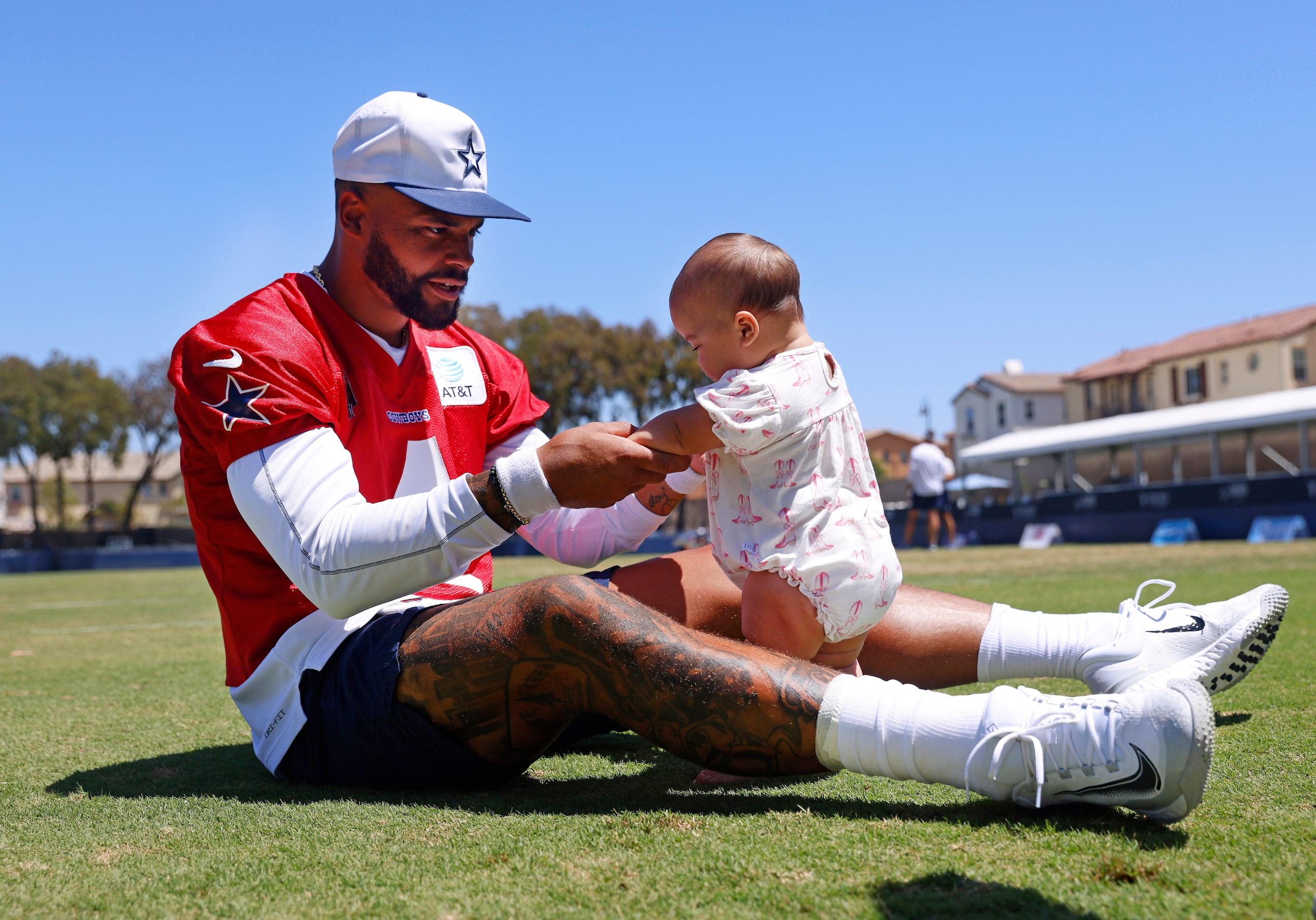 Dallas Cowboys quarterback Dak Prescott plays with his baby daughter Margaret Jane Rose...