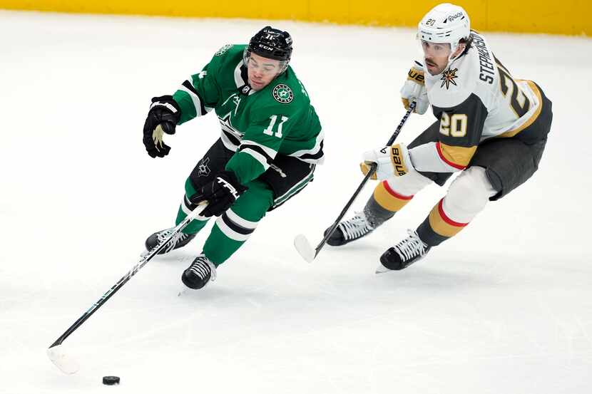 Dallas Stars center Logan Stankoven (11) looks to take control of the puck in front of Vegas...