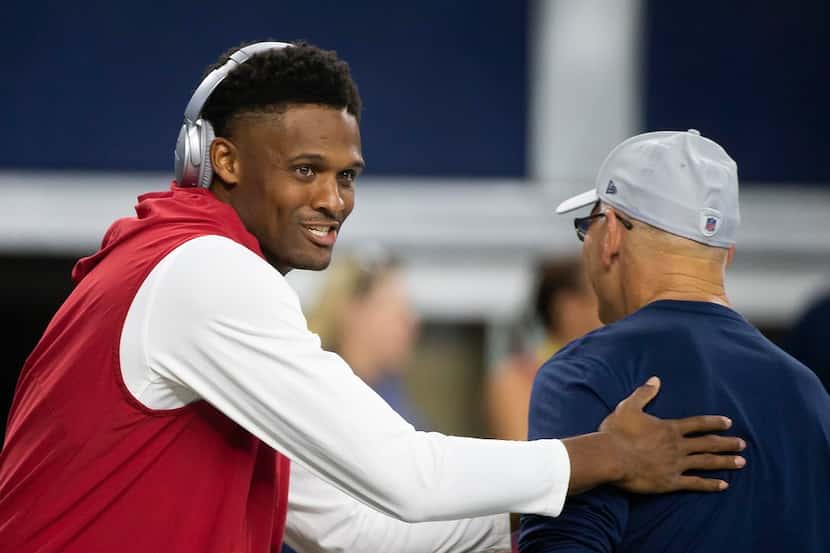 Wide receiver Brice Butler, then a member of the Arizona Cardinals, greets Cowboys defensive...